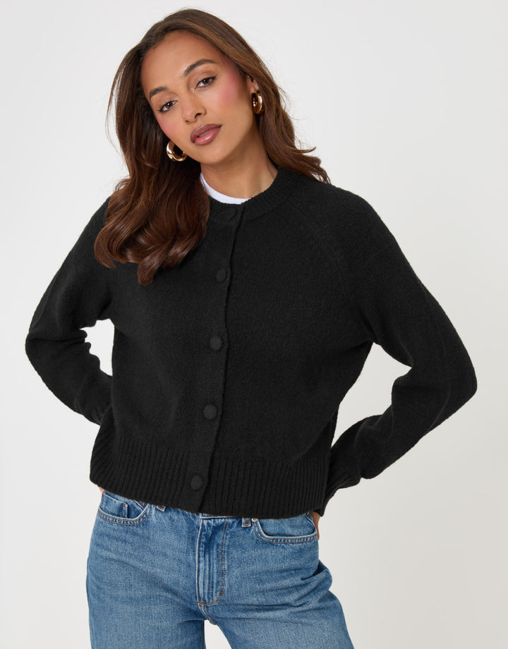 Threadbare The Relaxed Knitted Cardigan in Black - front hands on hips