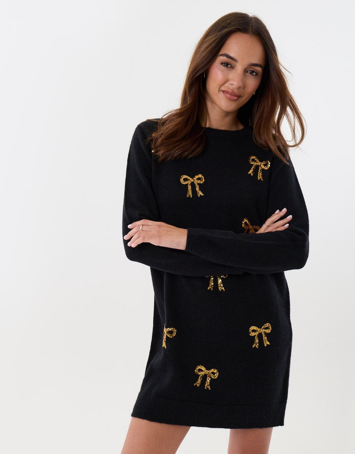 Threadbare Bow Embellished Knitted Mini Dress in Black - crossed arms front view