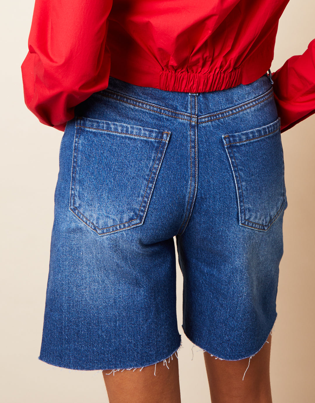 Raw Hem Denim Bermuda Shorts in Mid Wash