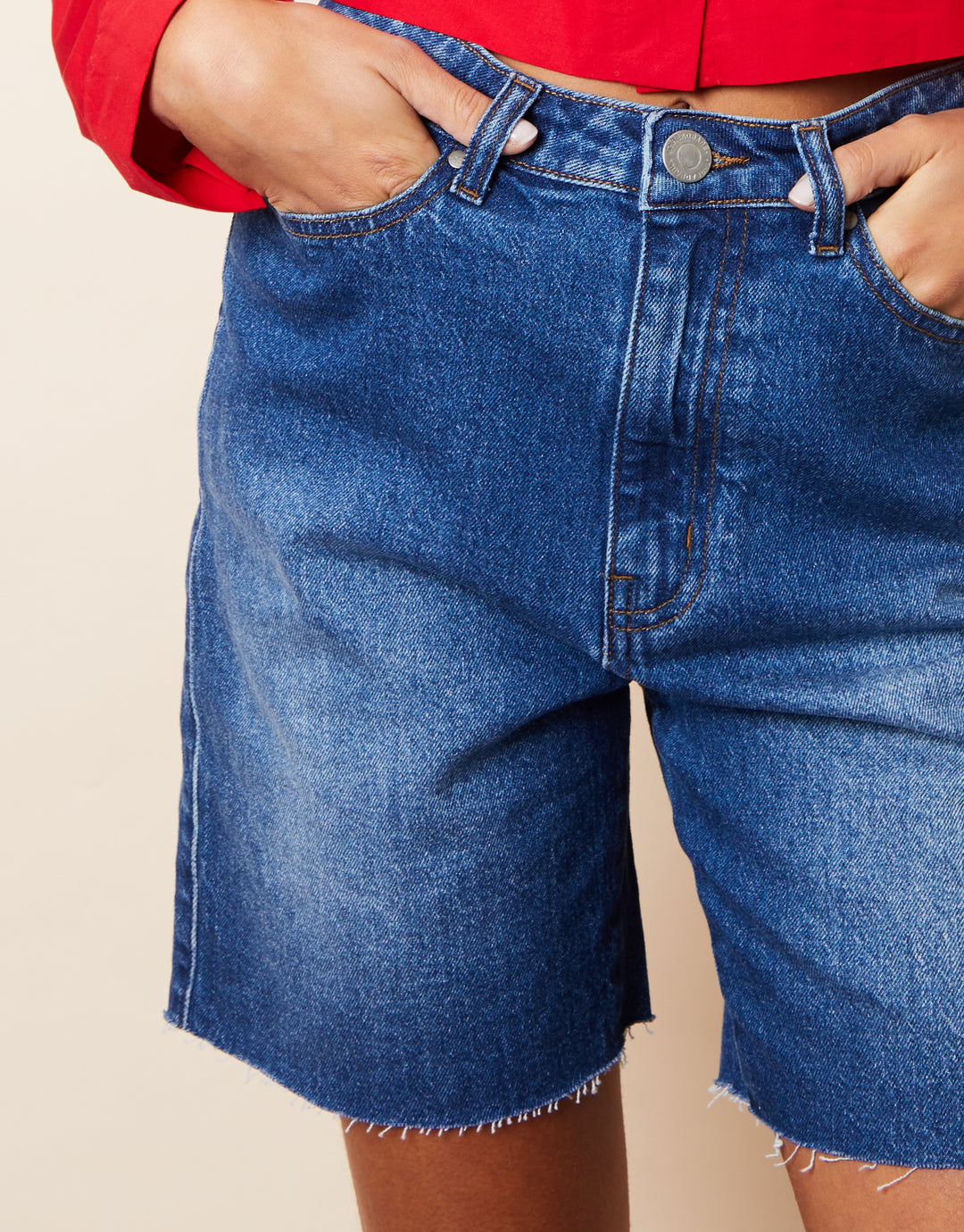 Raw Hem Denim Bermuda Shorts in Mid Wash