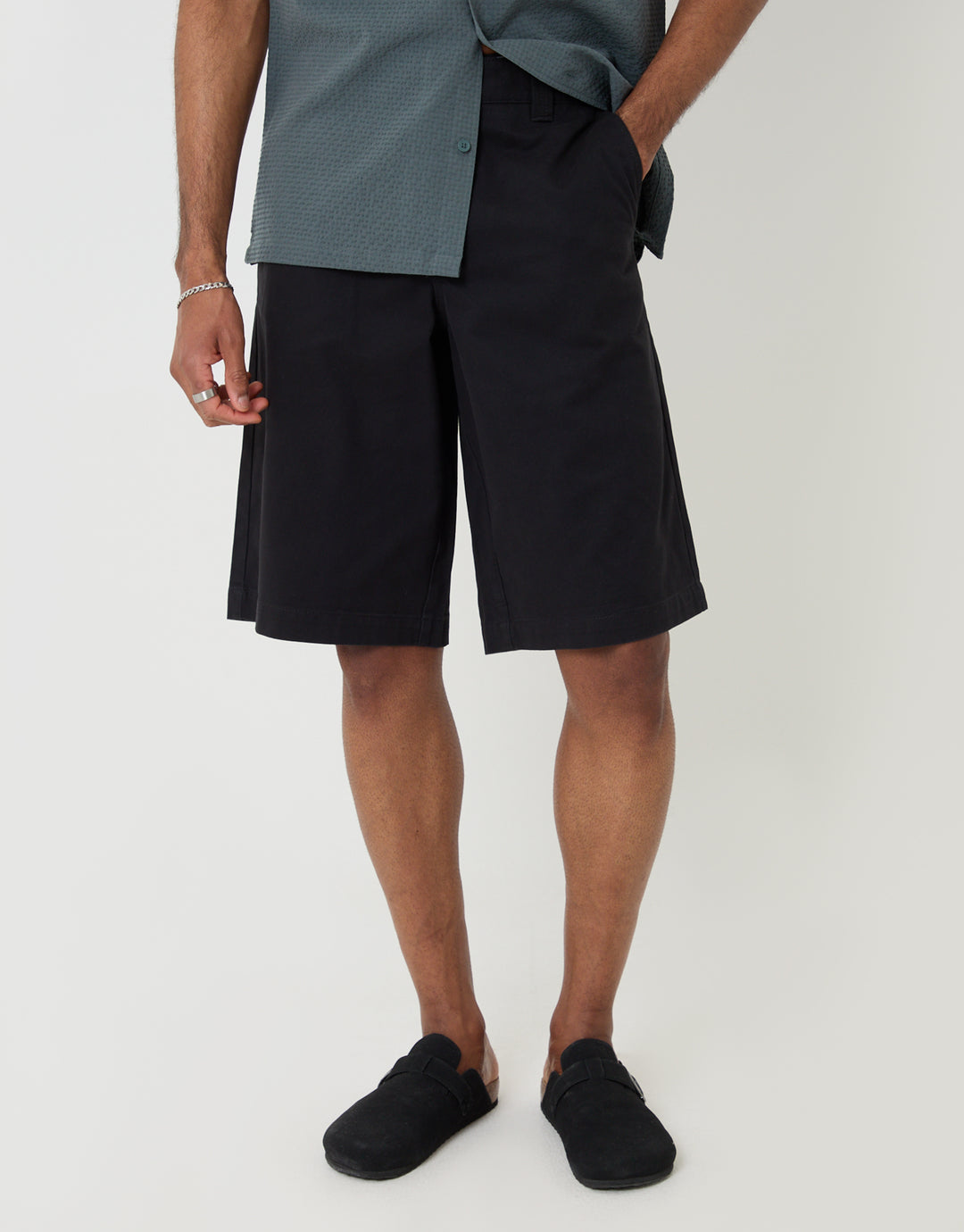 Threadbare Baggy Fit Cotton Chino Shorts in Black - front view, hand in pocket